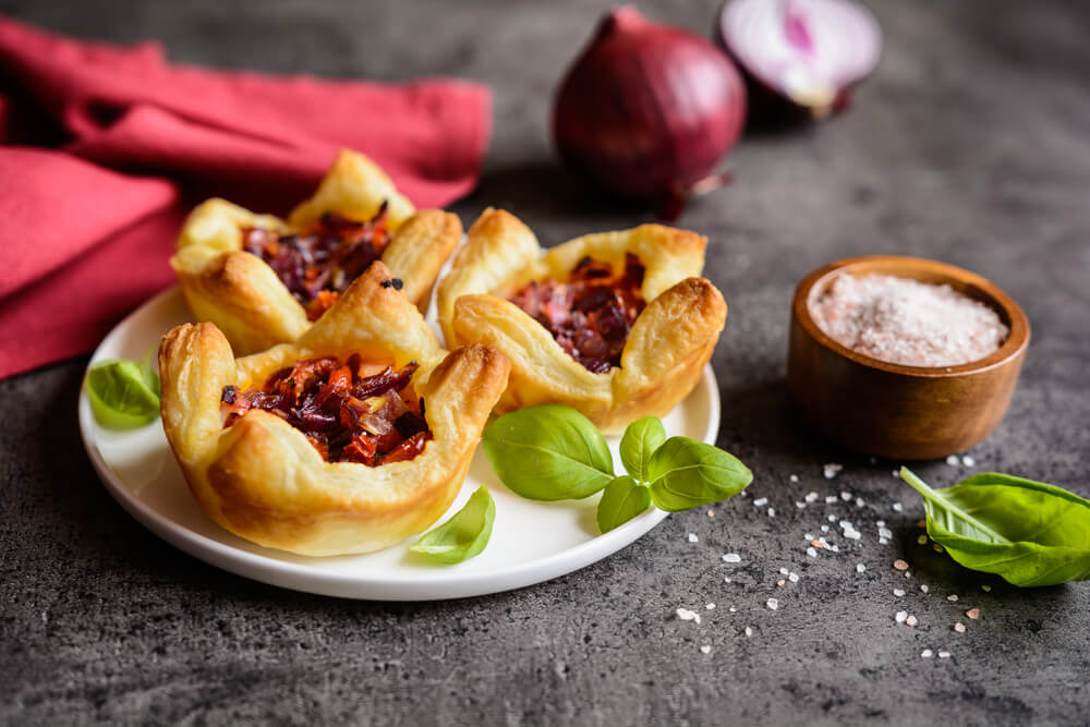 Mini tartlets with caramelised onion, chorizo and sun-dried tomato